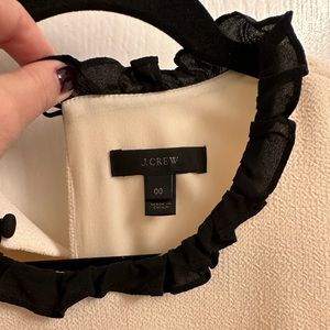 Cream crepe shift dress with black ruffle